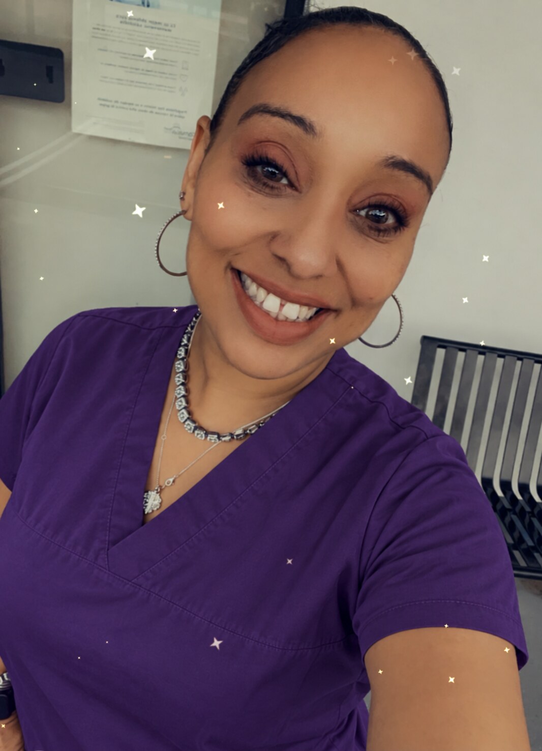 Jennie, owner of JennieYourGo2Girl, wearing purple scrubs